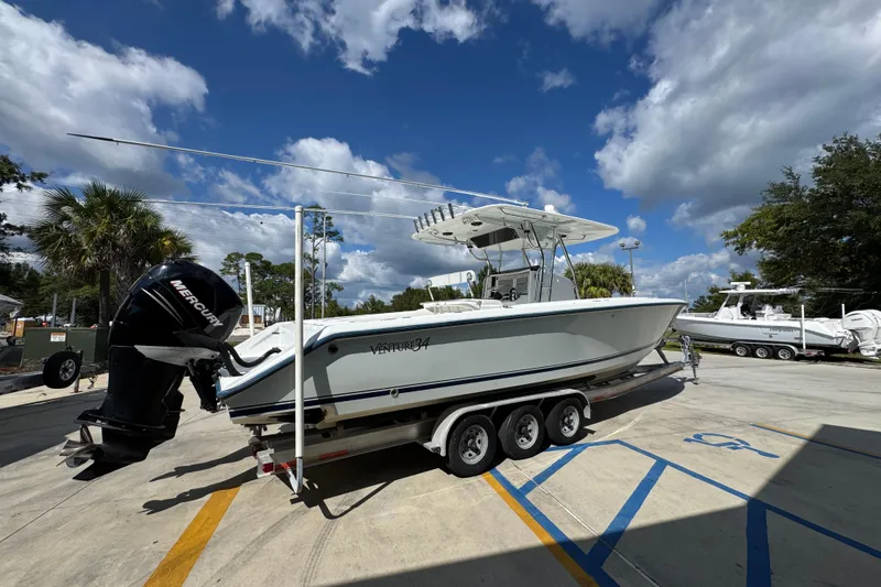  Yacht Photos Pics 2007 Venture 34 Open boat on trailer under blue sky with clouds.