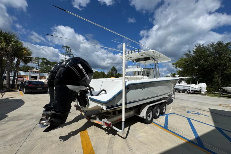  Yacht Photos Pics 2007 Venture 34 Open boat on trailer with Mercury outboard, parked outdoors under blue sky.