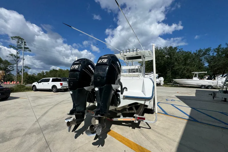  Yacht Photos Pics 2007 Venture 34 Open boat with dual Mercury 275 engines in a parking lot.