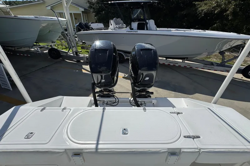  Yacht Photos Pics 2007 Venture 34 Open boat with dual outboard motors, parked near other boats.