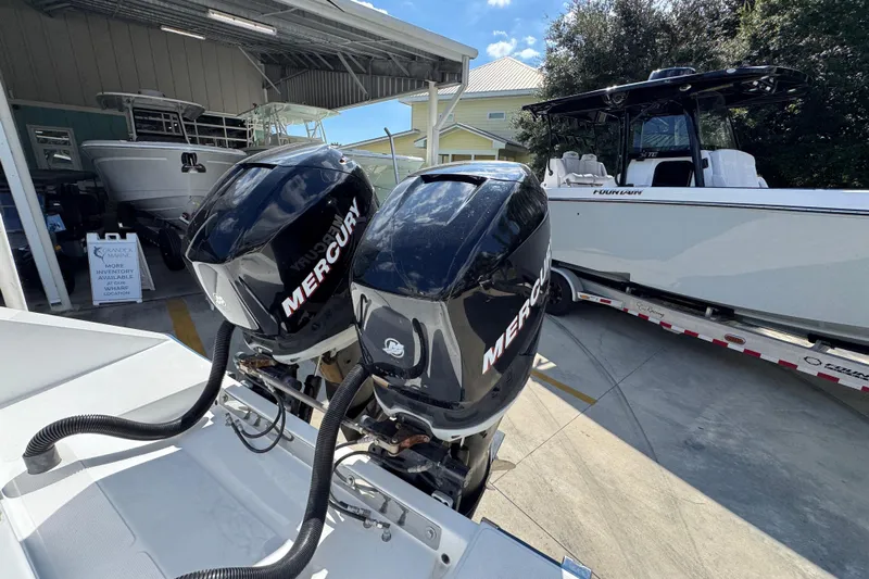  Yacht Photos Pics Twin Mercury outboard engines on a 2007 Venture 34 Open boat, parked near a trailer.