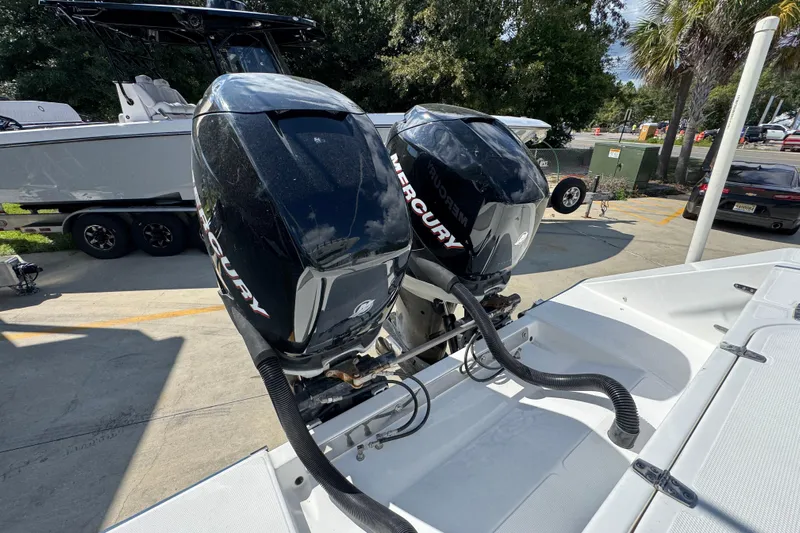  Yacht Photos Pics Twin Mercury outboard engines on a 2007 Venture 34 Open boat, parked outdoors.