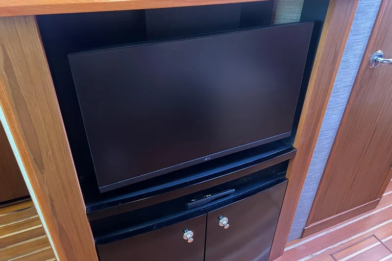  Yacht Photos Pics 2014 Tiara Yachts 3900 Coronet interior with TV and wooden cabinetry.