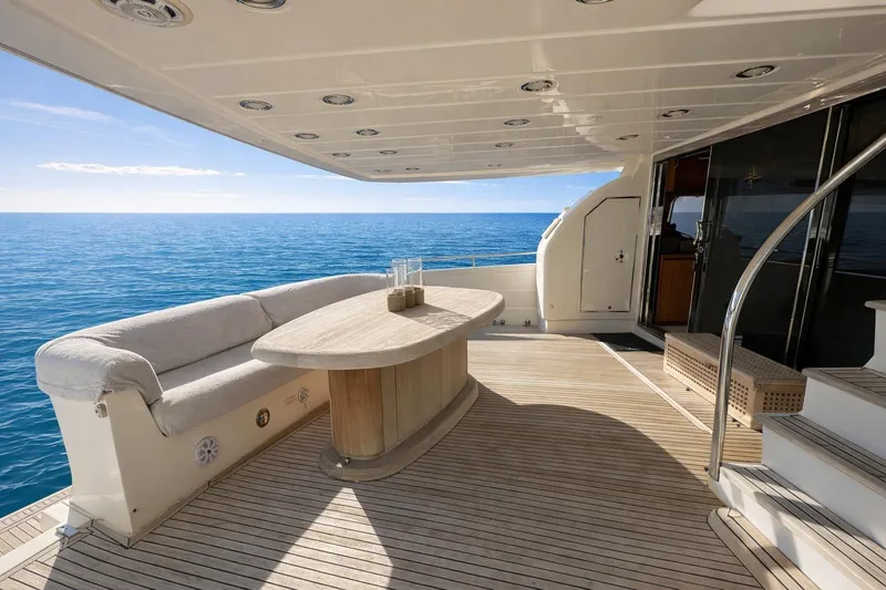 Agios Nikolaos I Yacht Photos Pics Luxury Posillipo Technema 80 yacht deck with seating, table, and ocean view, 2004 model.