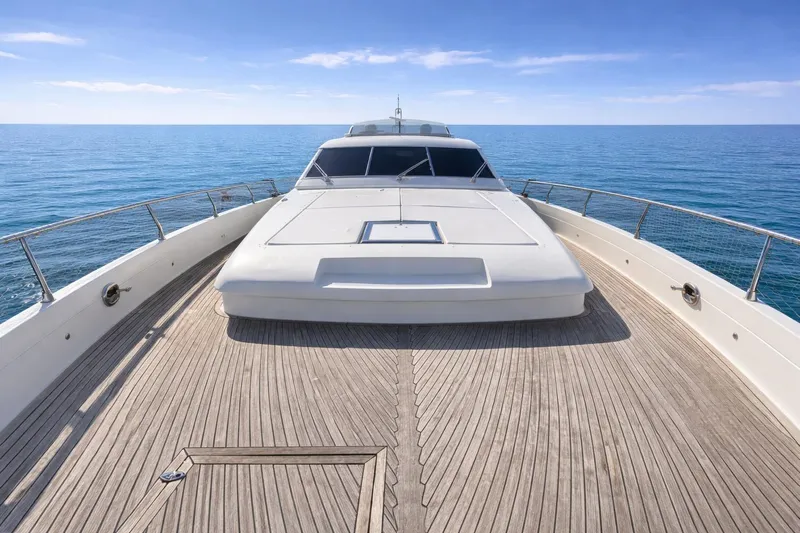 Agios Nikolaos I Yacht Photos Pics Luxury Posillipo Technema 80 yacht deck, 2004 model, cruising on calm blue sea.