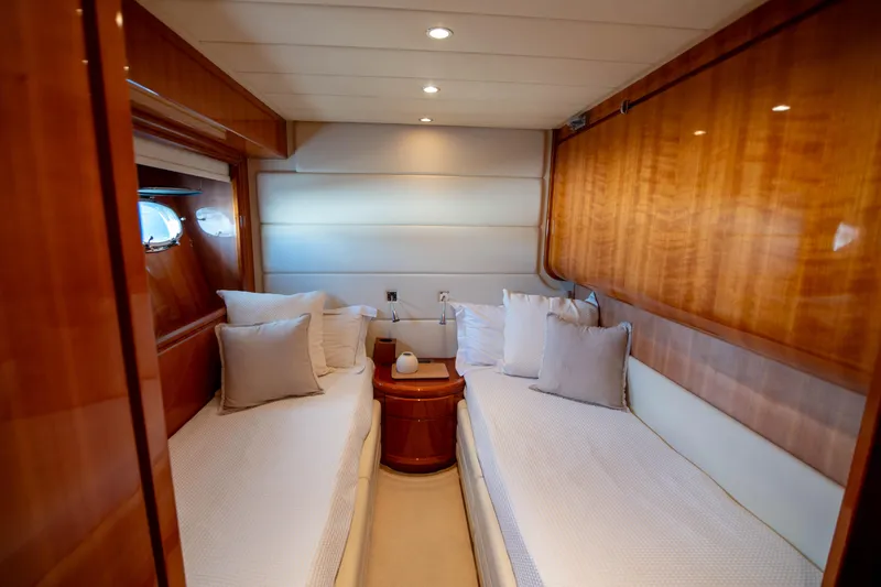 Agios Nikolaos I Yacht Photos Pics Luxurious twin cabin interior on 2004 Posillipo Technema 80 yacht, featuring elegant wood paneling.