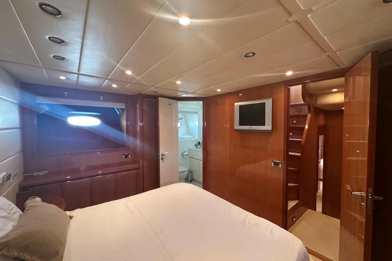 Agios Nikolaos I Yacht Photos Pics Luxurious bedroom interior of 2004 Posillipo Technema 80 yacht with modern amenities.