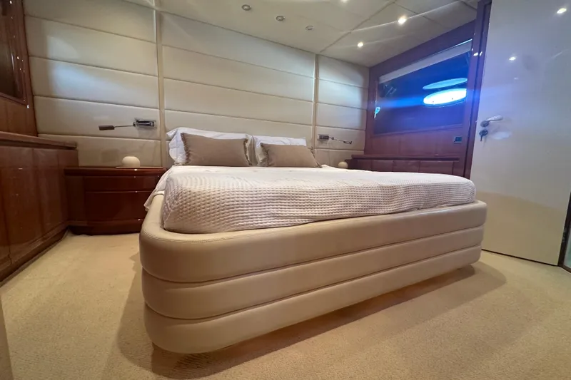 Agios Nikolaos I Yacht Photos Pics Luxurious bedroom interior of 2004 Posillipo Technema 80 yacht with elegant furnishings.