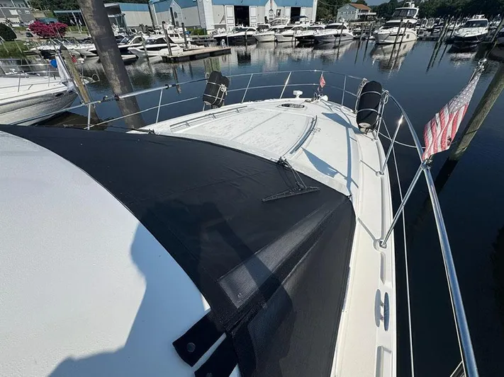  Yacht Photos Pics 2015 Sea Ray 510 Sundancer yacht docked at marina, featuring sleek design and American flag.