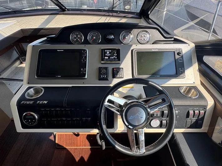  Yacht Photos Pics Helm of 2015 Sea Ray 510 Sundancer with modern navigation controls and steering wheel.