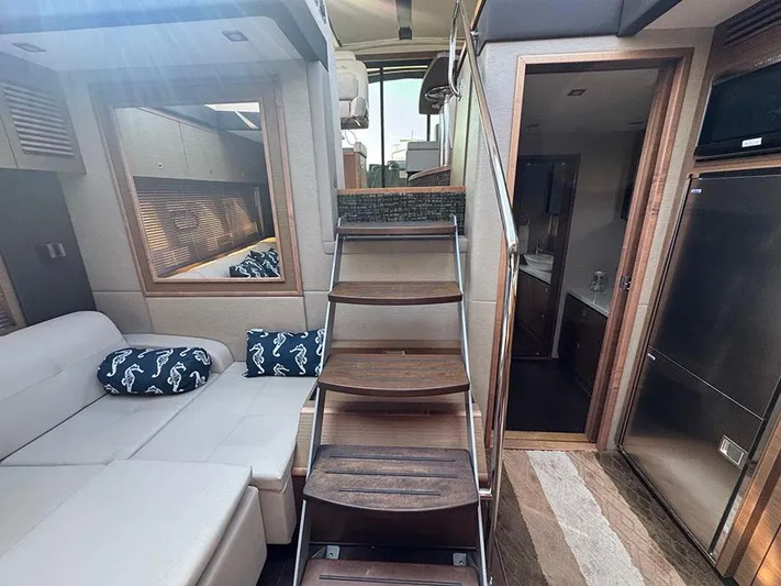  Yacht Photos Pics Luxurious interior of 2015 Sea Ray 510 Sundancer yacht with wooden stairs and modern furnishings.