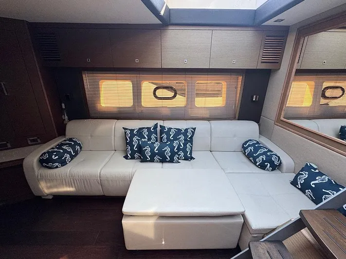  Yacht Photos Pics Luxurious interior of 2015 Sea Ray 510 Sundancer with white leather seating and seahorse-patterned cushions.