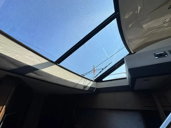  Yacht Photos Pics Interior view of 2015 Sea Ray 510 Sundancer with sunroof and clear blue sky.