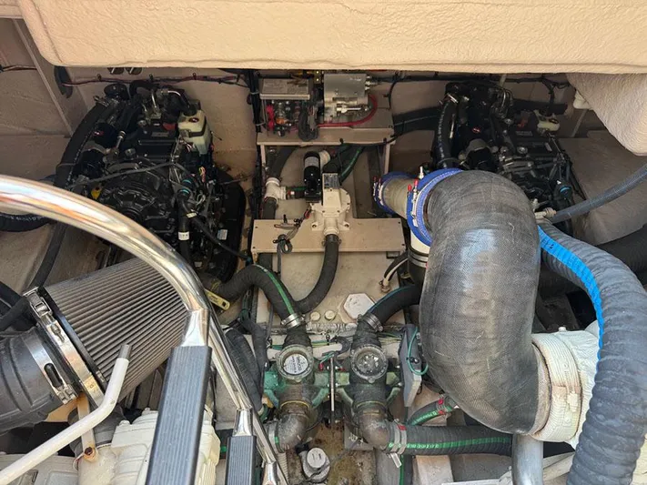  Yacht Photos Pics Engine compartment of a 2015 Sea Ray 510 Sundancer, showcasing mechanical components and hoses.