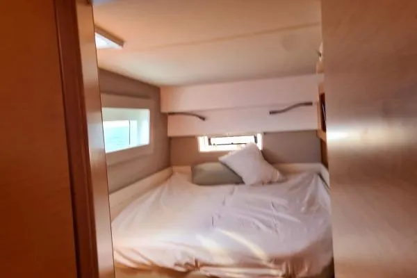 Kaikira Yacht Photos Pics Cozy bedroom interior of 2019 Nautitech 46 catamaran with window views.