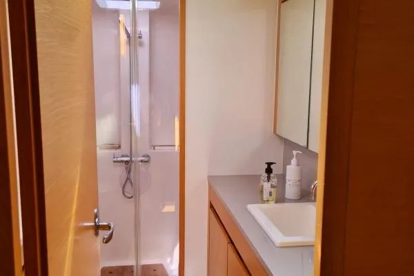 Kaikira Yacht Photos Pics Modern bathroom interior on a 2019 Nautitech 46 yacht, featuring a shower and sink.