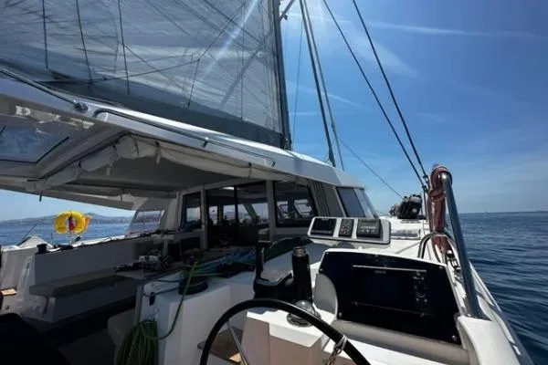 Kaikira Yacht Photos Pics 2019 Nautitech 46 catamaran sailing on open sea under clear blue sky.