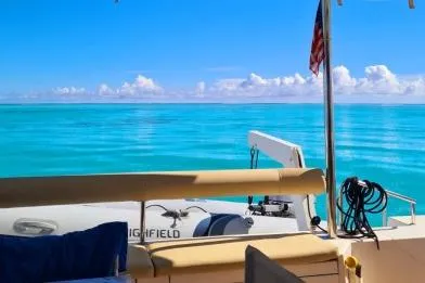 Kaikira Yacht Photos Pics Nautitech 46 catamaran, 2019 model, on tranquil turquoise waters under a clear blue sky.