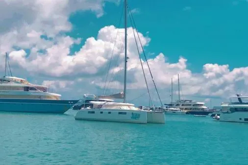 Kaikira Yacht Photos Pics 2019 Nautitech 46 catamaran docked in a sunny marina with other boats.