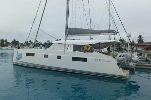 Kaikira Yacht Photos Pics 2019 Nautitech 46 catamaran docked in a serene marina setting.