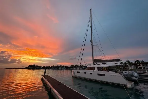 Kaikira Yacht Photos Pics 2019 Nautitech 46 catamaran docked at sunset with vibrant sky.