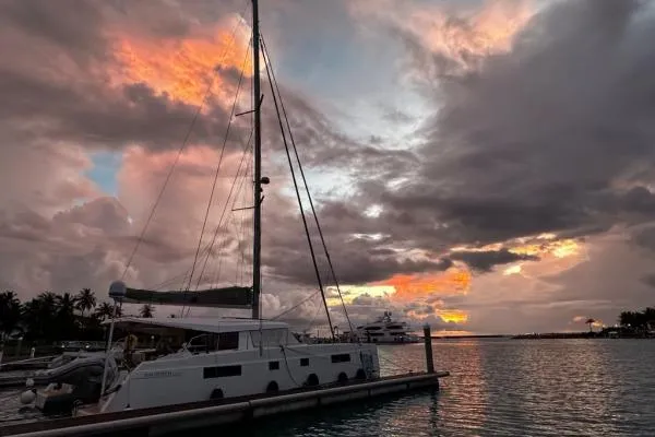 Kaikira Yacht Photos Pics 2019 Nautitech 46 catamaran docked at sunset with vibrant sky.