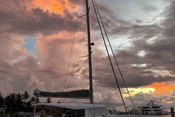 Kaikira Yacht Photos Pics 2019 Nautitech 46 catamaran at sunset with dramatic clouds and palm trees.
