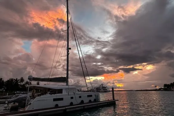 Kaikira Yacht Photos Pics Nautitech 46 catamaran docked at sunset, 2019 model, with vibrant sky and calm waters.