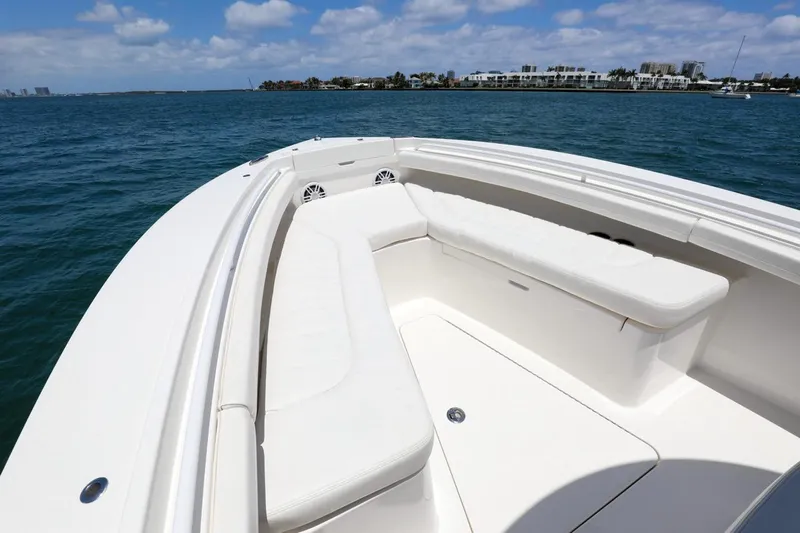  Yacht Photos Pics 2024 Regulator 23 boat with spacious seating, cruising on a sunny day.