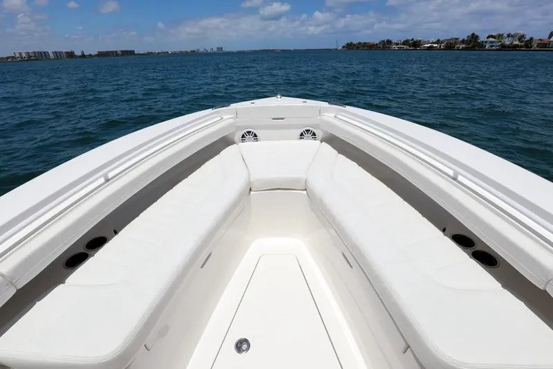  Yacht Photos Pics 2024 Regulator 23 boat bow with seating, on a sunny day at sea.