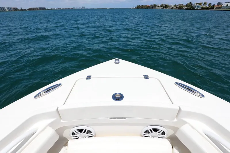  Yacht Photos Pics 2024 Regulator 23 boat bow on open water, clear sky, coastal view.