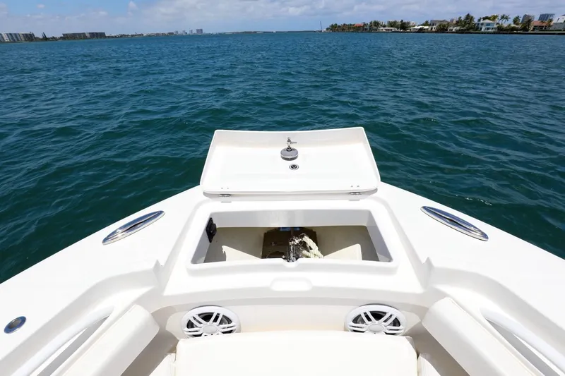  Yacht Photos Pics 2024 Regulator 23 boat on open water, featuring spacious deck and storage compartment.