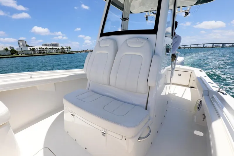  Yacht Photos Pics 2024 Regulator 23 boat interior with white seating, on a sunny day by the water.