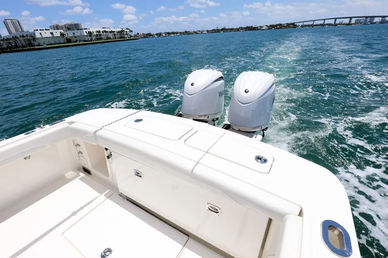  Yacht Photos Pics 2024 Regulator 23 boat cruising on open water with twin engines.