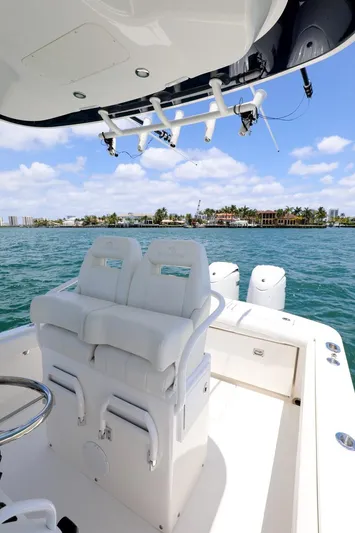  Yacht Photos Pics 2024 Regulator 23 boat interior with white seating, ocean view, and clear blue sky.