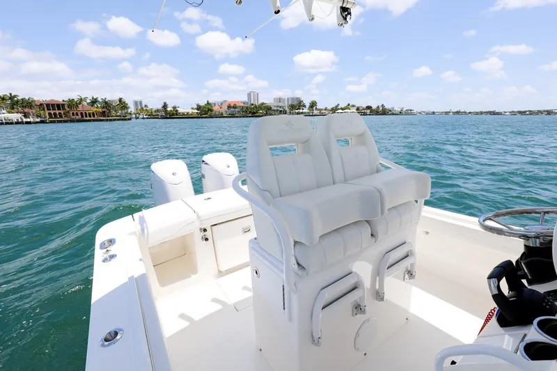  Yacht Photos Pics 2024 Regulator 23 boat with dual seats on a sunny day at sea.