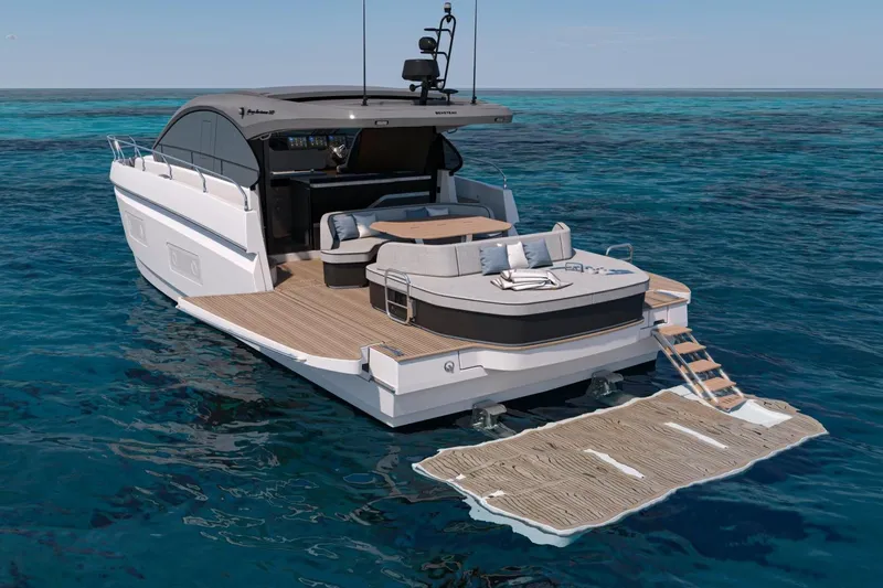  Yacht Photos Pics 2026 Beneteau Gran Turismo 50 yacht on open water, featuring luxurious deck and seating area.