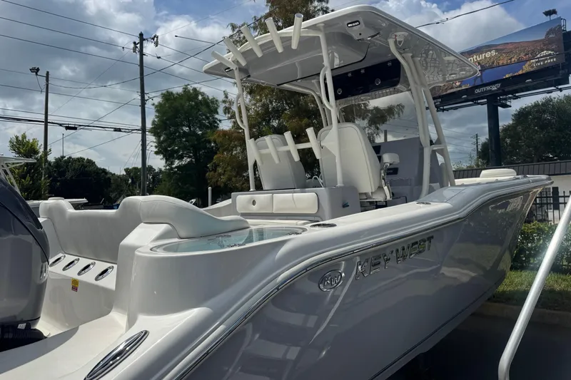  Yacht Photos Pics 2025 Key West 263 FS boat with sleek design, parked outdoors under cloudy sky.