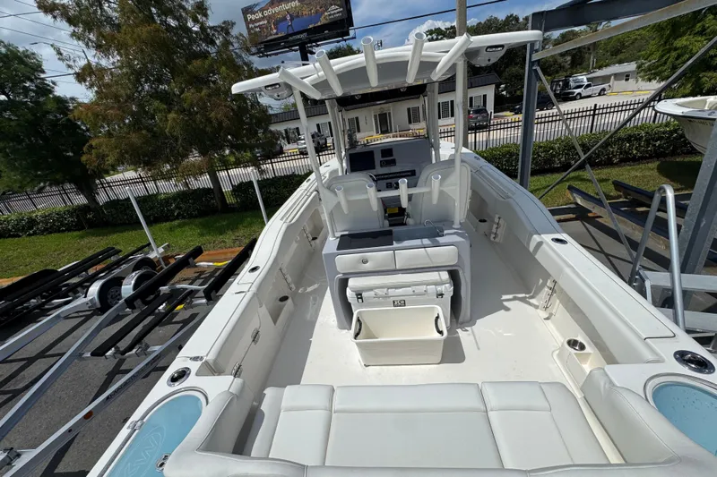  Yacht Photos Pics 2025 Key West 263 FS boat interior with seating and console, parked outdoors.