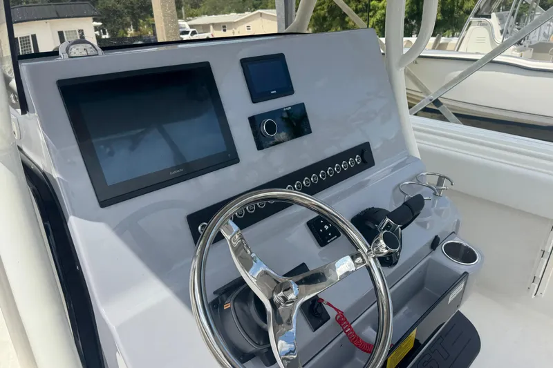  Yacht Photos Pics 2025 Key West 263 FS boat dashboard with steering wheel and electronic displays.