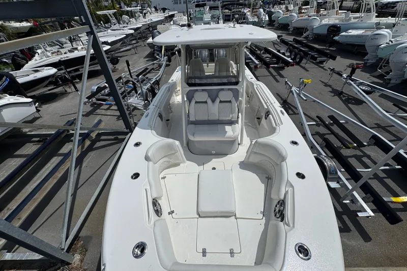 Yacht Photos Pics 2025 Key West 263 FS boat in a marina, surrounded by trailers and other boats.