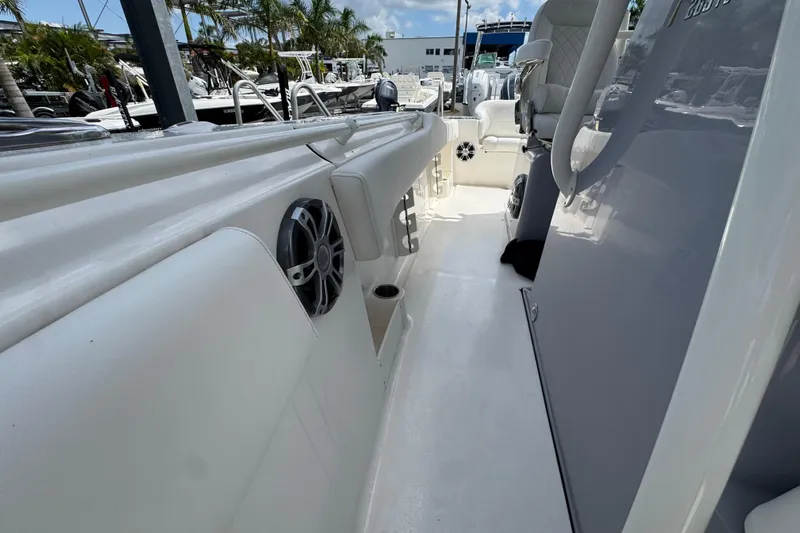  Yacht Photos Pics 2025 Key West 263 FS boat interior with seating and speakers, docked under clear skies.