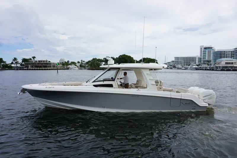 Iboat 3 Yacht Photos Pics 2019 Boston Whaler 350 Realm boat cruising on a calm waterway.