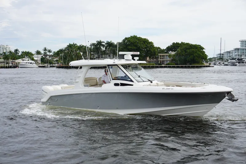 Iboat 3 Yacht Photos Pics 2019 Boston Whaler 350 Realm cruising on a calm waterway.