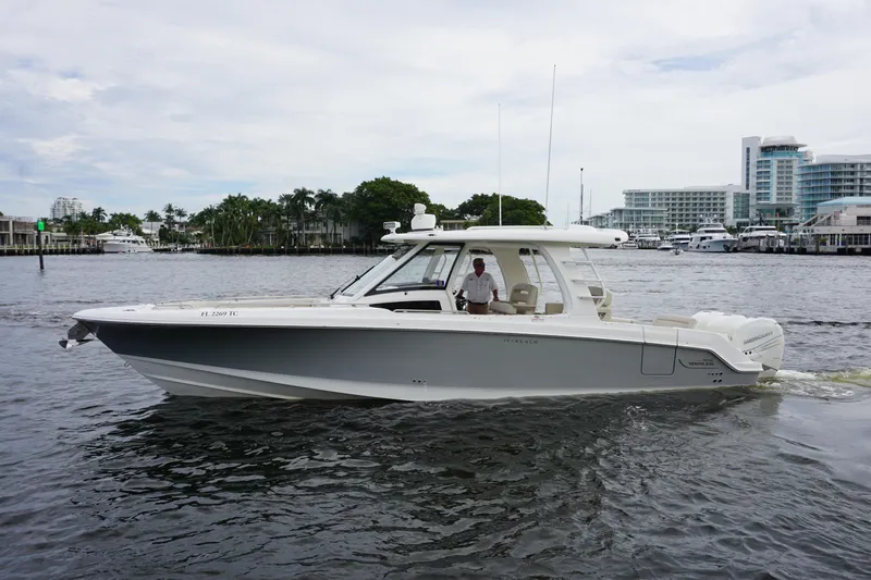 Iboat 3 Yacht Photos Pics 2019 Boston Whaler 350 Realm boat cruising on a calm waterway.