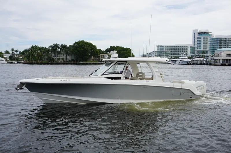 Iboat 3 Yacht Photos Pics 2019 Boston Whaler 350 Realm cruising on a calm waterfront.