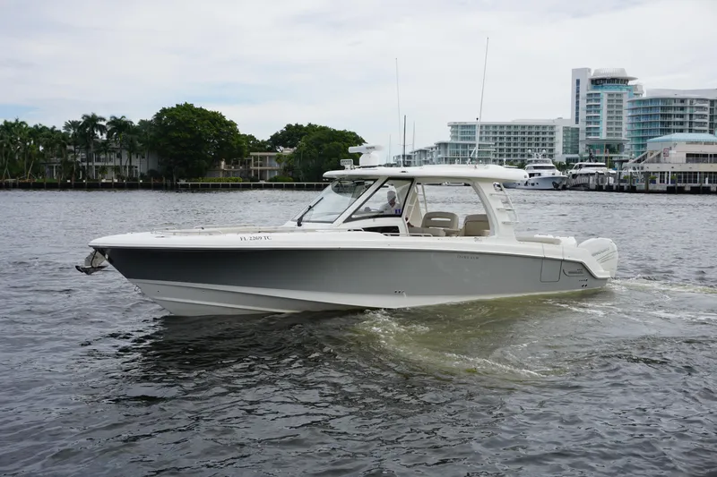 Iboat 3 Yacht Photos Pics 2019 Boston Whaler 350 Realm boat cruising on a calm waterway.