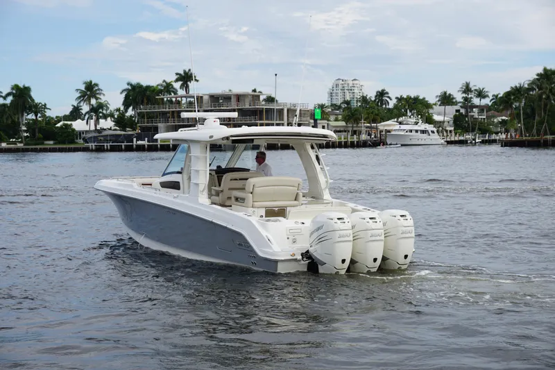 Iboat 3 Yacht Photos Pics 2019 Boston Whaler 350 Realm boat cruising on a calm waterway.