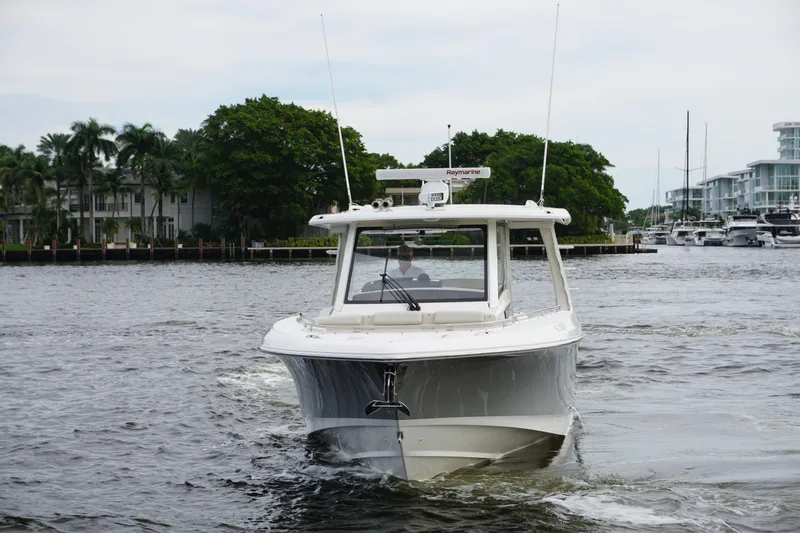Iboat 3 Yacht Photos Pics 2019 Boston Whaler 350 Realm boat cruising on a calm waterway.