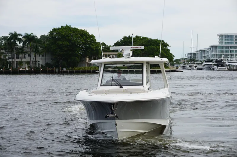 Iboat 3 Yacht Photos Pics 2019 Boston Whaler 350 Realm boat cruising on a calm waterway.